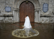 Bride Jamaica Agular prepares to enter the flooded Barasoain church for her wedding in Malolos, Bulacan province, Philippines on Tuesday, July 22, 2025. Aaron Favila/AP