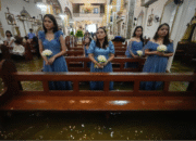 Bridemaids attend a wedding ceremony at the flooded Barasoain church in Malolos, Bulacan province, Philippines on Tuesday, July 22, 2025. Aaron Favila/AP