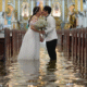 Newlyweds Jade Rick Verdillo right, and Jamaica kiss during their wedding at the flooded Barasoain church in Malolos, Bulacan province, Philippines on Tuesday, July 22, 2025. Aaron Favila/AP